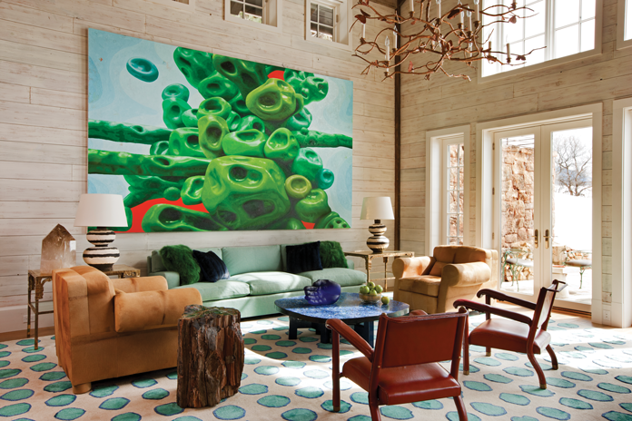 The living room features a custom wool silk rug from Studio Four and a bold painting by Alex Ross. The Lapis Lazuli table is by Ado Chale.