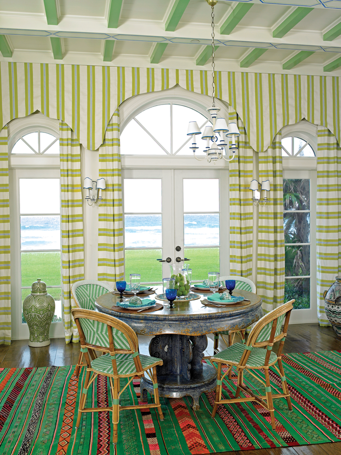 The breakfast room is grounded by a vintage green stripe carpet from Marrakech.