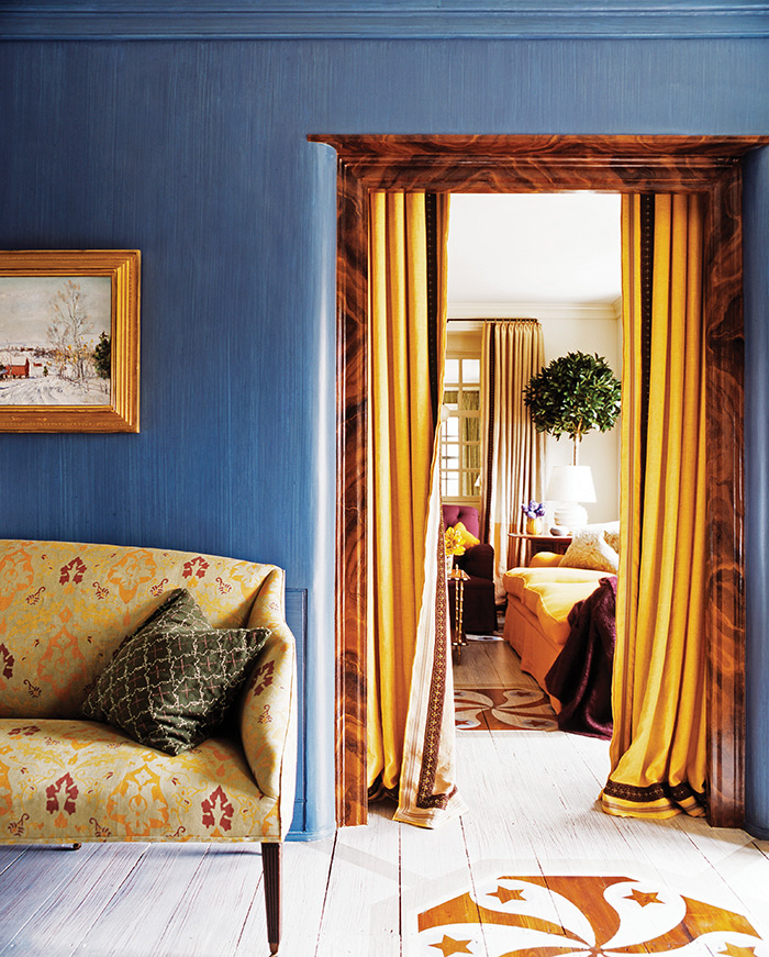 A painted and stenciled floor is used as a visual connection between the entry and living room. Photo by Jillian Wass.