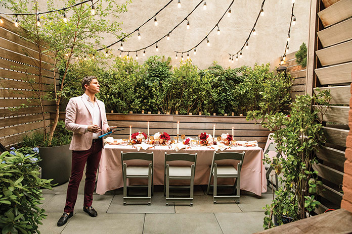 Image of David Burtka outside with a table